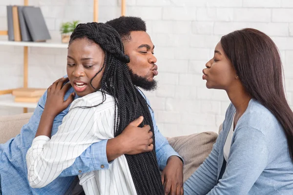 Unfaithful Black Boyfriend Kissing Another Girl While Hugging His Girlfriend