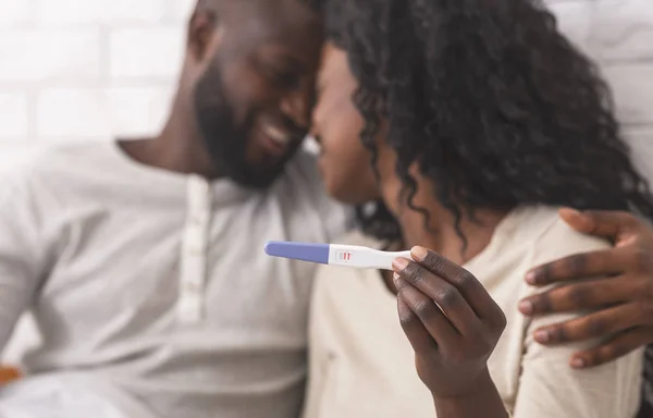 Feliz pareja afro celebración de la prueba de embarazo con resultado positivo —  Fotos de Stock