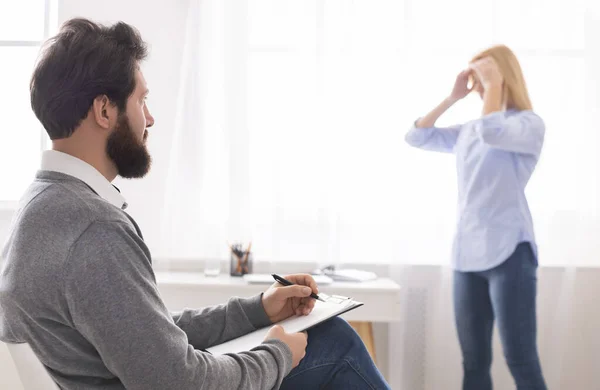 Psicoterapeuta escuchando a una mujer desesperada durante la terapia — Foto de Stock