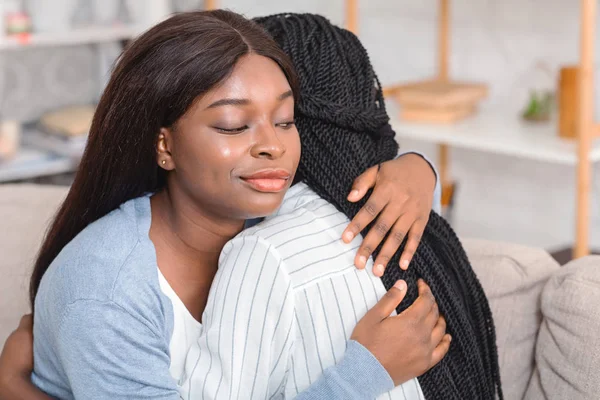 Fake Friendship. Indifferent Girl Rolling Eyes Hugging Crying Friend Sitting On Couch At Home. Selective Focus — Stock Photo, Image