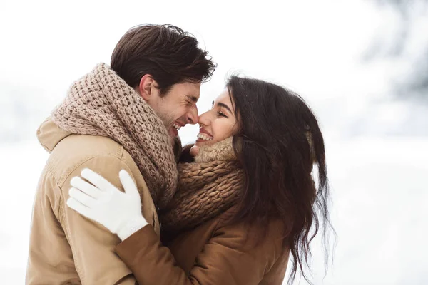 Sweet Couple Rubbing Their Noses Hugging Standing In Snowy Forest — ストック写真