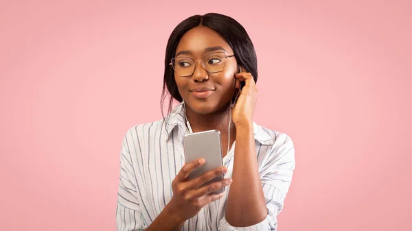 Girl using Phone Listening To Audio Book Standing, Studio Shot — Stok Foto