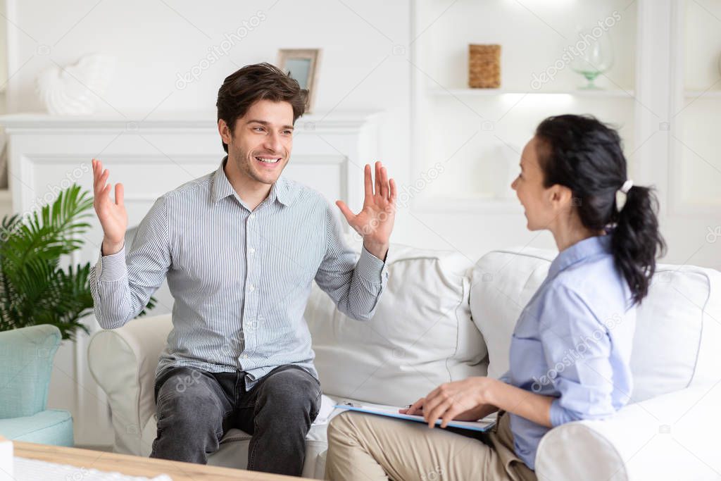 Excited man sharing his positive emotions with therapist