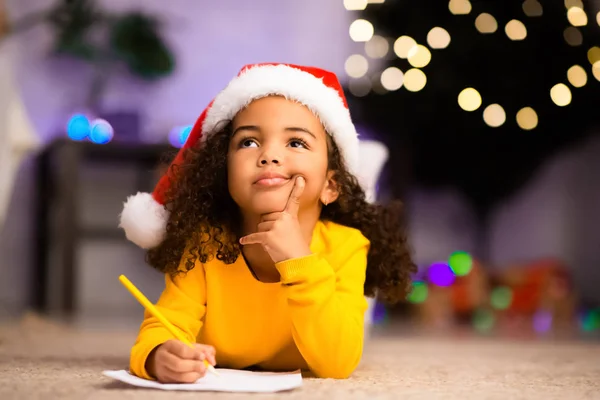 Menina afro Wistful pouco pensando sobre a carta ao Papai Noel — Fotografia de Stock