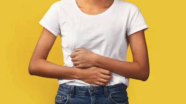 Cropped image of black woman suffering from stomachache — Stock Photo, Image