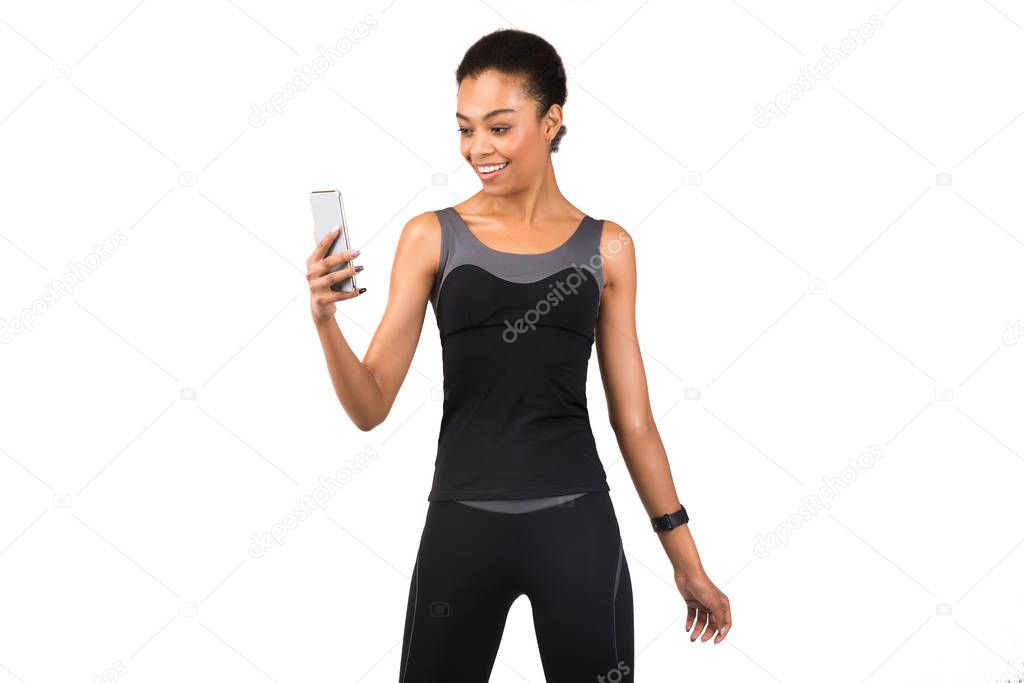 Fit Afro Girl Using Smartphone Standing Over White Background, Isolated