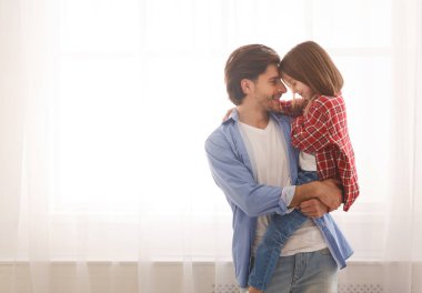 Sevgi dolu baba küçük anaokulu kızını taşıyor.