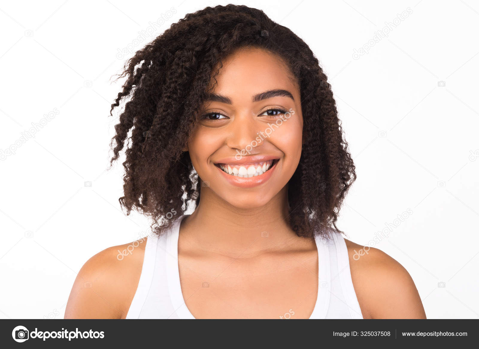Beautiful african american woman smiling at camera Stock Photo by ©Milkos  325037508