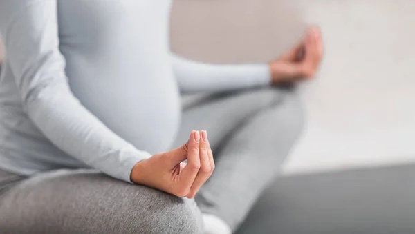 Cropped image of young expectant meditating at home — Stock Photo, Image