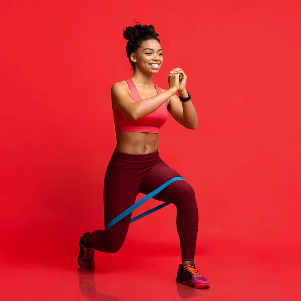 Alegre afro fitness menina fazendo exercício com banda de resistência — Fotografia de Stock