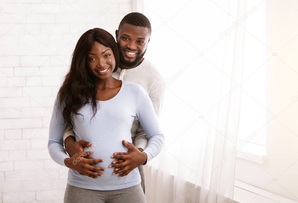 Portrait of happy african couple expecting baby