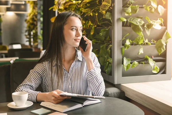 Vrouwelijke marketing manager maakt mobiel onderhandelen in café — Stockfoto