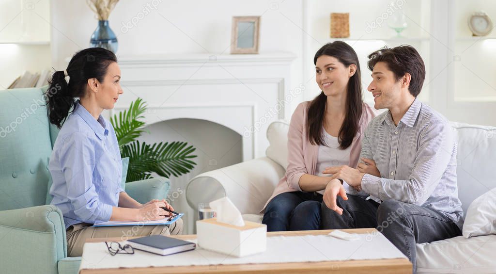 Psychologist and happy couple after effective marital therapy