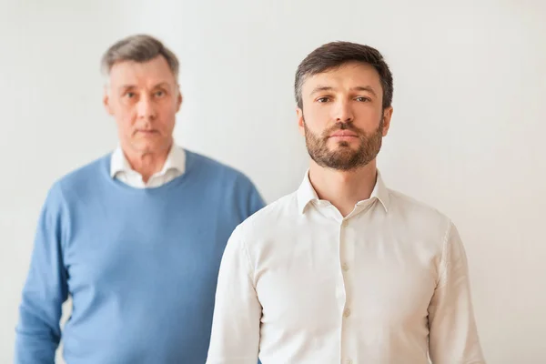 Middle-Aged Son And Elderly Father Standing On White Background — 图库照片