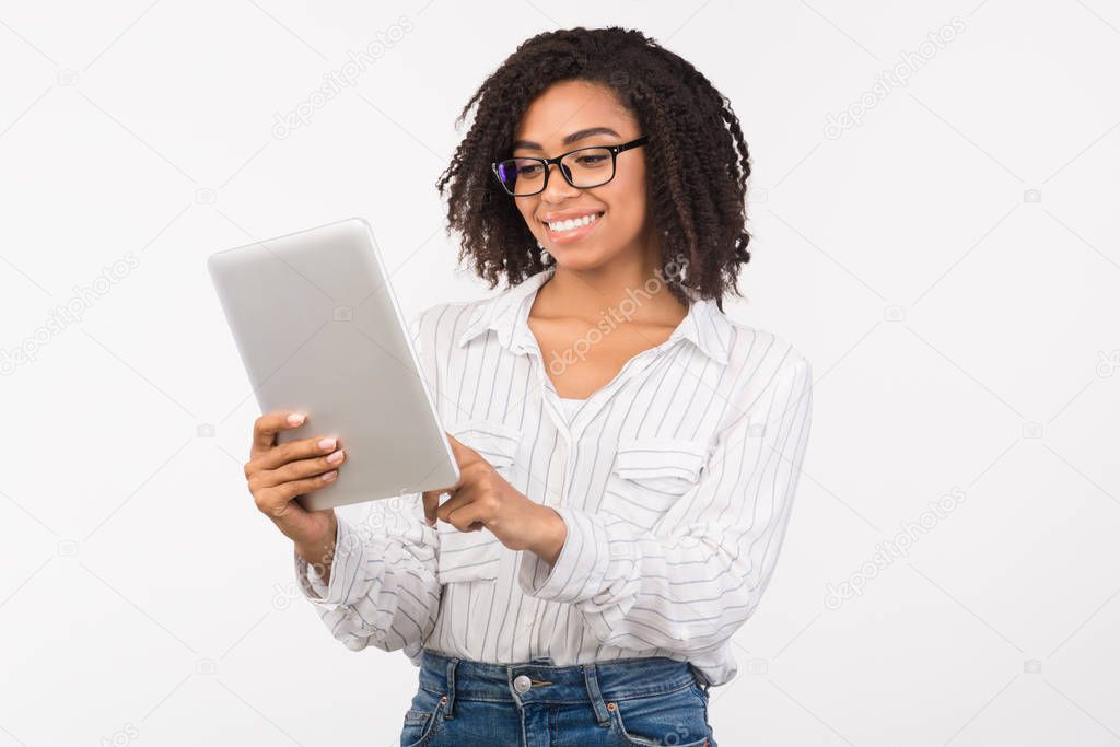 African american girl in eyewear using digital tablet