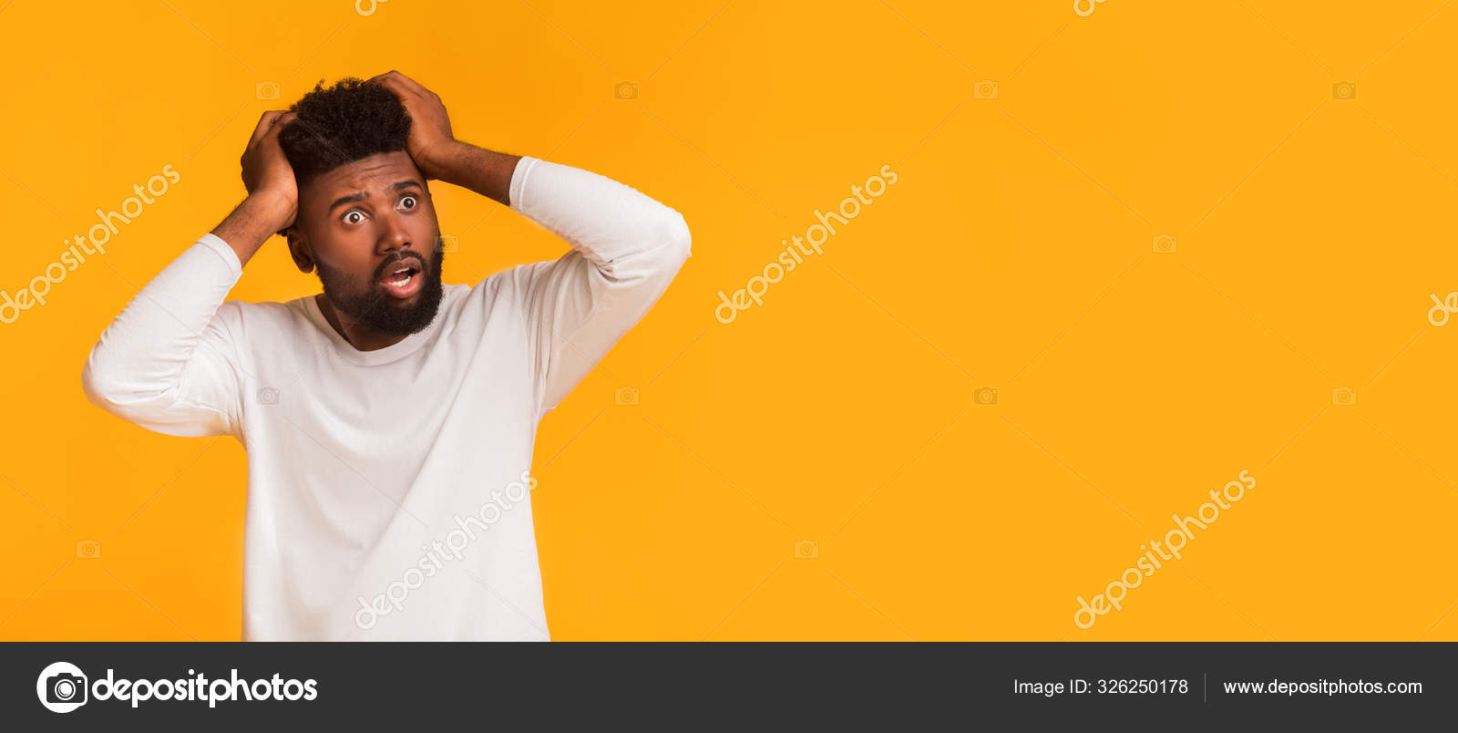 Shocked black guy touching head and looking at copy space Stock Photo ...