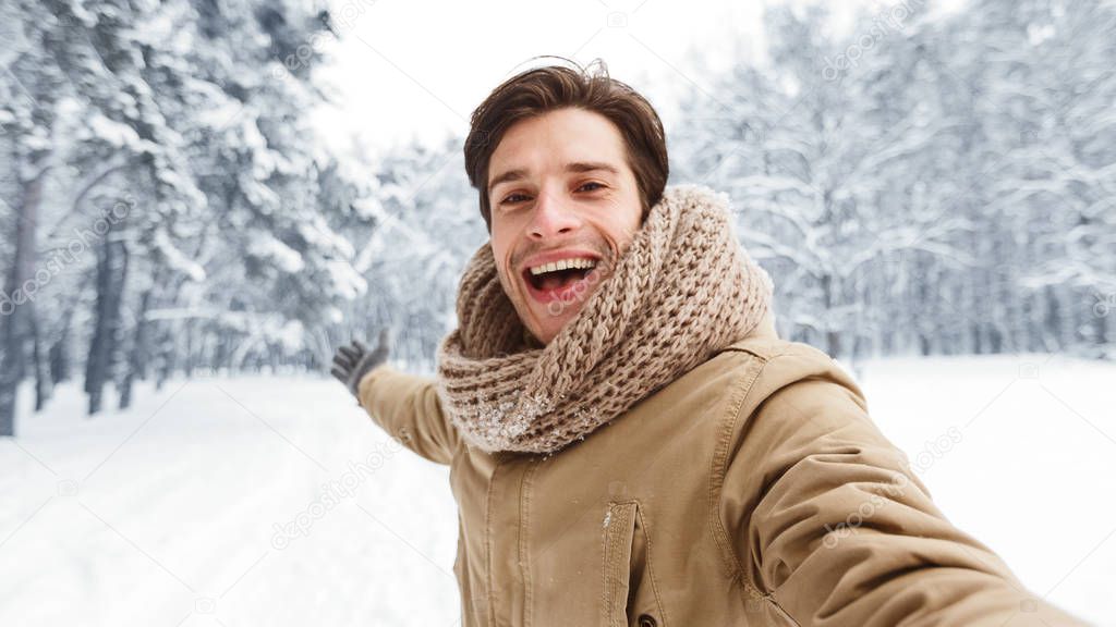 Joyful Guy Making Selfie In Snowy Park Walking Outdoors, Panorama