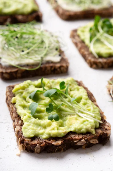 Vegan sandwiches with avocado and fresh microgreen — Stock Photo, Image