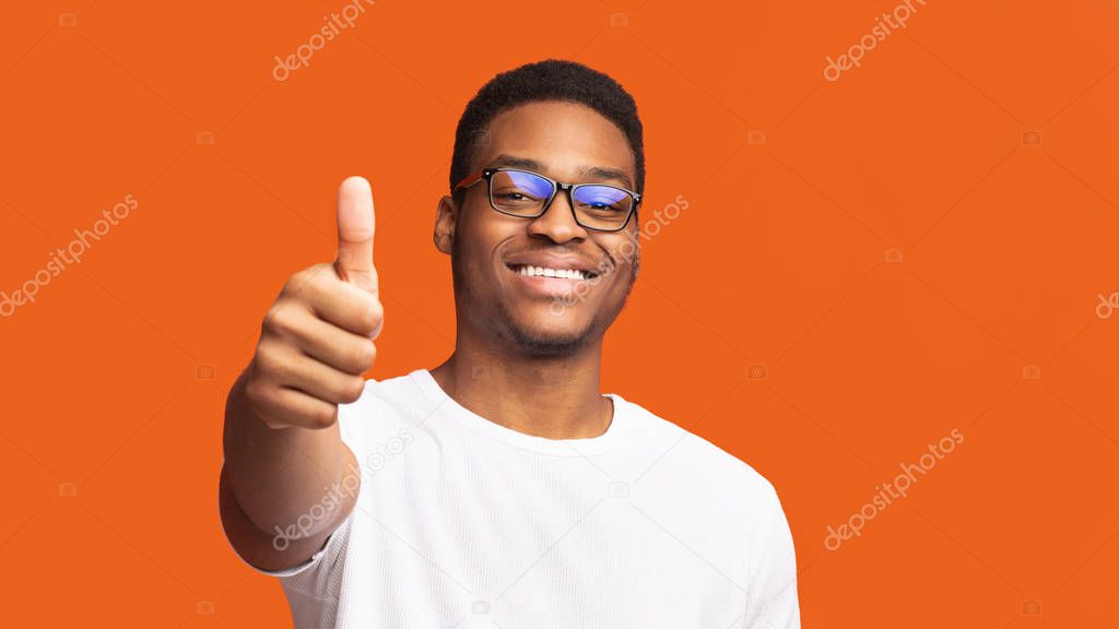 African american guy showing thumb up and smiling