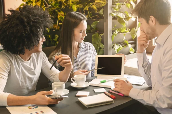 Mujer mostrando información sobre la pantalla de la tableta a sus colegas — Foto de Stock