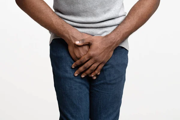 Close up of black man holding his crotch — Stock Image Close up of black man holding his crotch Royalty Free Stock Images