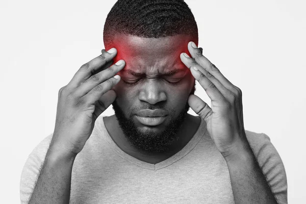 Man suffering from headache, touching his temples — Stock Photo, Image