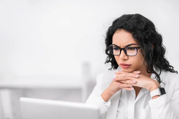 Serieuze latin manager op zoek naar haar computer — Stockfoto