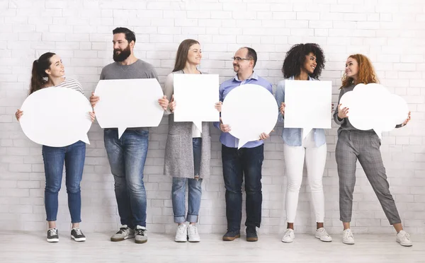 Group of diverse people with white speech bubbles — Stock Photo, Image