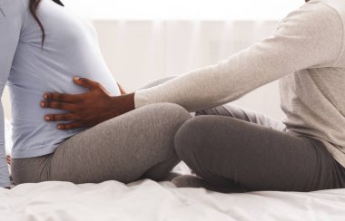 Erkeğin hamile karısının karnına dokunuşuna yakın dur.