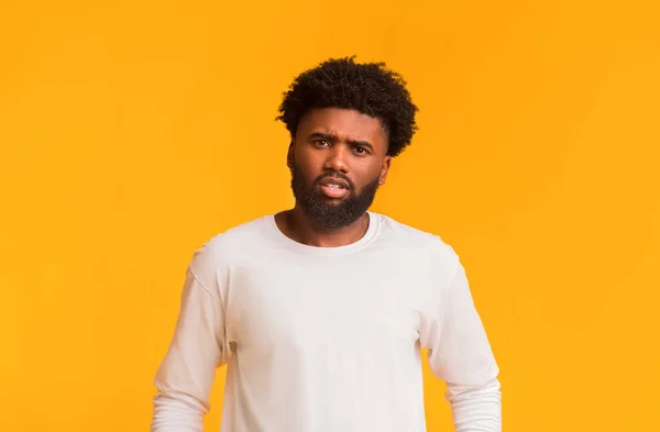 Indignant young afro man over orange background — 스톡 사진