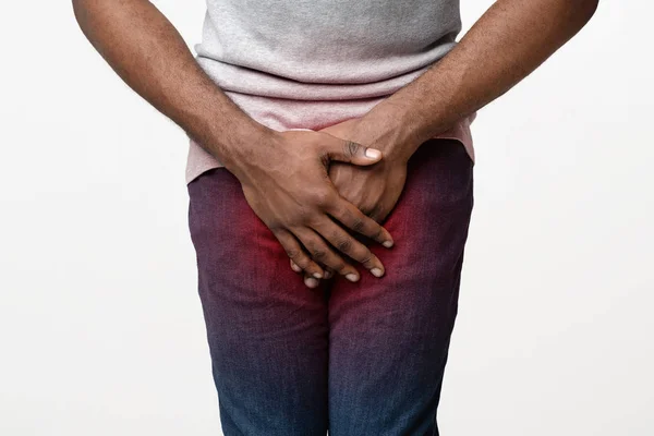 Close up of afro guy covering his crotch with palms — Stock Photo, Image