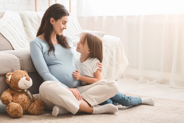 Pregnant mother and her happy daughter playing together — Stock Photo, Image