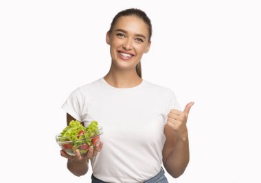 Lady Holding Vegetable Salad Gesturing Thumbs-Up Approving Diet, Studio Shot