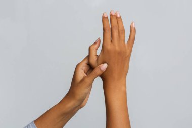 Cropped of black woman massaging her hand joints