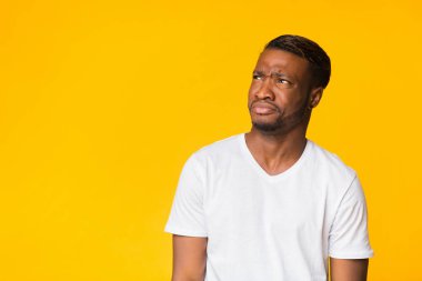 Disgusted African American Man Looking Aside Standing, Studio Shot clipart