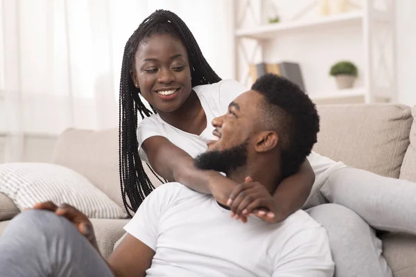 Happy black spouses resting at home, cuddling and spending time together — 스톡 사진