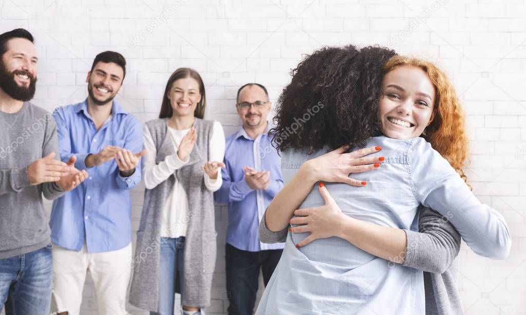 Rehab group members embracing during group therapy session