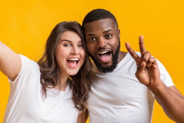 Irklar arası çift selfie çekiyor, kadın afro erkek arkadaşıyla fotoğraf çekiyor.