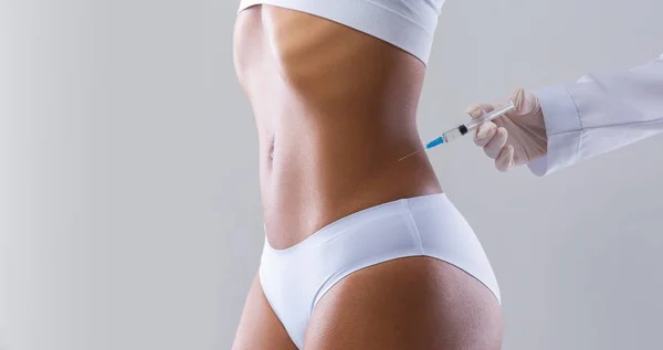 Cropped of black woman having injection in her waist — 스톡 사진