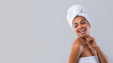 Cheerful black girl after shower looking at free space clipart