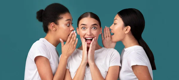 Three Diverse Women Whispering Sharing Secrets Over Turquoise Background, Panorama — Stock Photo, Image