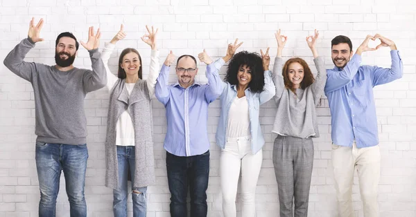 Cheerful funny millennials posing with different gestures — Stock Photo, Image