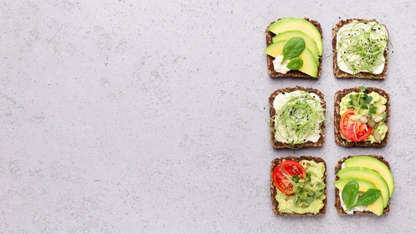 Assortment of vegan toasts with avocado, tofu and microgreens — Stock Photo, Image