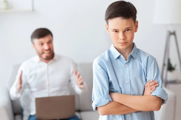 Furious Father Shouting At Son Sitting On Sofa At Home — Stock Photo, Image