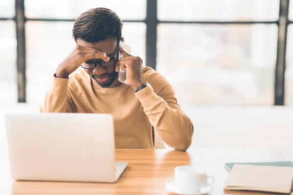 Upset african manager receiving sad news on the phone — Stock Photo, Image