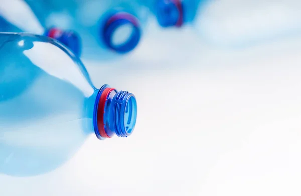 Empty plastic bottles in raw on white background