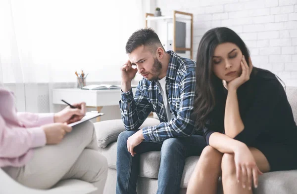 Casal estressado sentado separadamente no escritório do conselheiro familiar — Fotografia de Stock