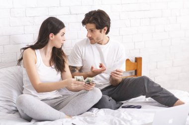 Young husband and wife accounting taxes and money left