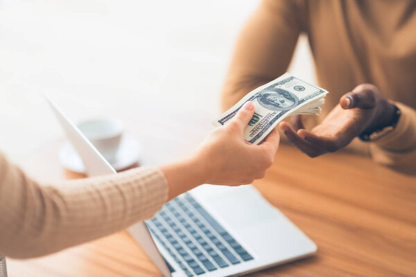 Black man receiving bribe money from partner