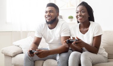 Cheerful African American Couple Playing Video Games At Home Together